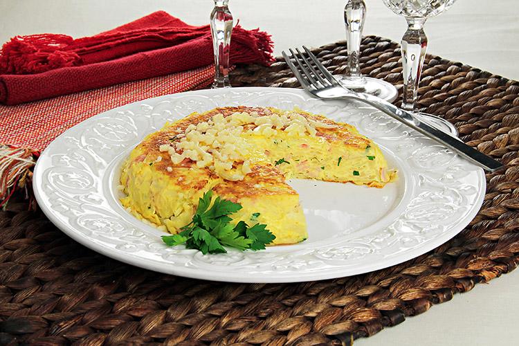 Aprenda essa deliciosa Receita de Fritada rostie. Ela leva batata, ovos, presunto, requeijão, manteiga e queijo parmesão. Rápida e rende 2 porções.