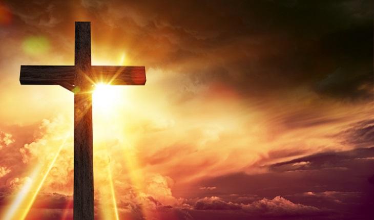 Na imagem há uma cruz fazendo sombra para os raios de sol ao fundo. A foto ilustra a existência de um dos 7 céus