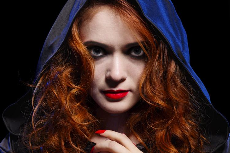 mulher ruiva com batom vermelho e capuz azul